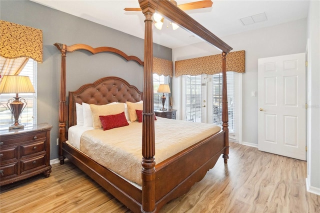 bedroom with light wood-type flooring, ceiling fan, access to exterior, and multiple windows