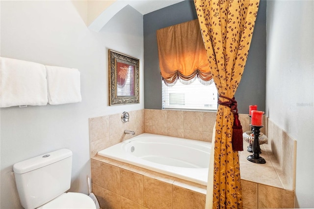 bathroom featuring toilet and tiled tub