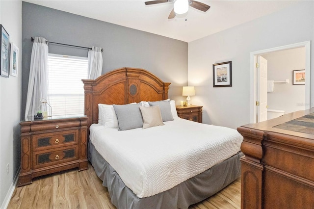 bedroom with light hardwood / wood-style floors, ceiling fan, and ensuite bath