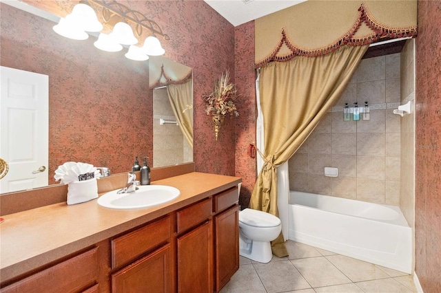 full bathroom featuring toilet, vanity, tile patterned floors, and shower / bath combo with shower curtain