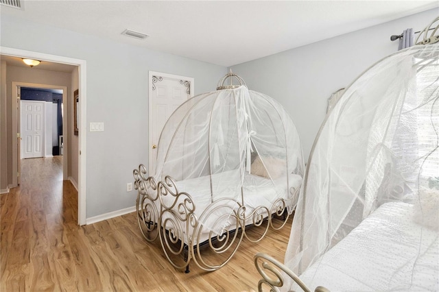 bedroom with hardwood / wood-style flooring