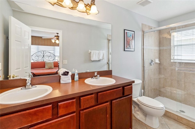 bathroom featuring a shower with door, a wealth of natural light, vanity, and toilet