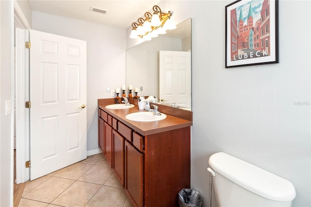 bathroom with tile patterned flooring, vanity, and toilet