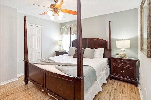 bedroom featuring ceiling fan, light hardwood / wood-style flooring, and a closet