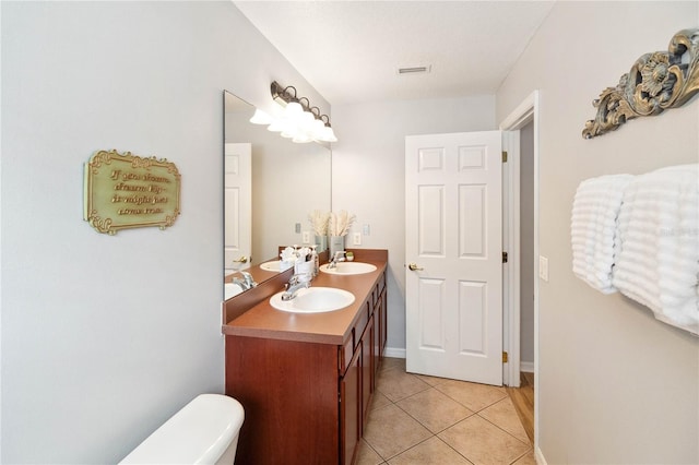 bathroom featuring vanity, tile patterned floors, and toilet