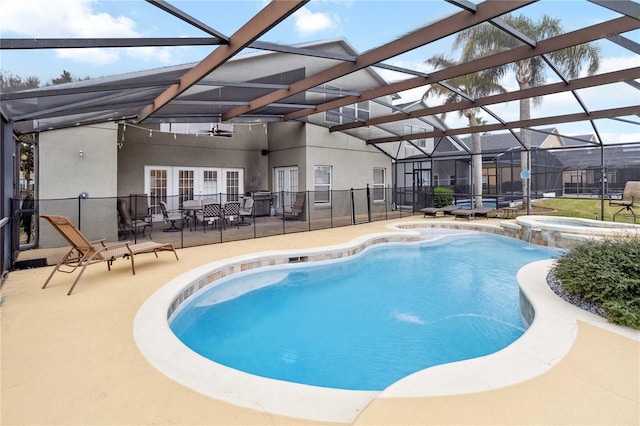 view of pool featuring french doors, a patio, glass enclosure, and an in ground hot tub