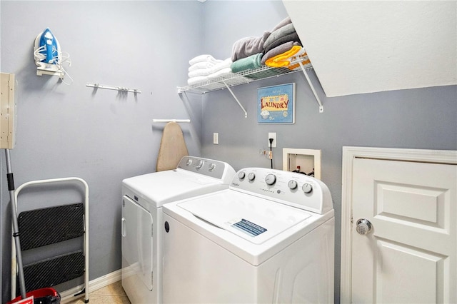 washroom featuring washer and dryer and light tile patterned flooring