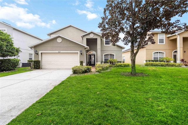 view of front of property featuring a garage, driveway, a front lawn, and stucco siding