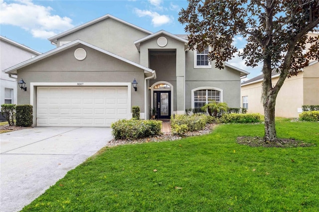 traditional-style house featuring a garage, a front lawn, concrete driveway, and stucco siding