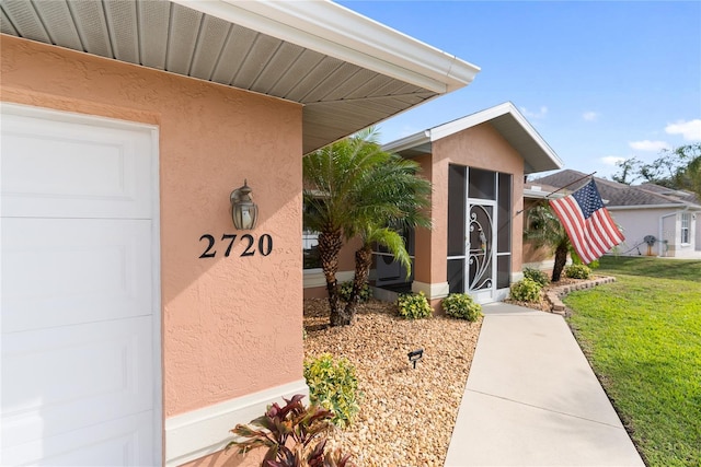 entrance to property featuring a yard