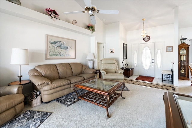 living room with ceiling fan and a towering ceiling