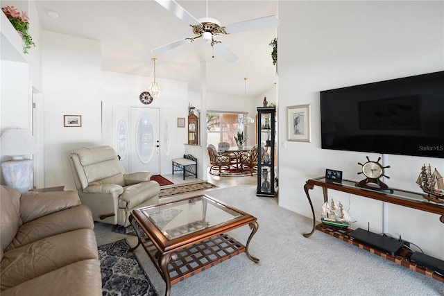 living room featuring vaulted ceiling, carpet floors, and ceiling fan