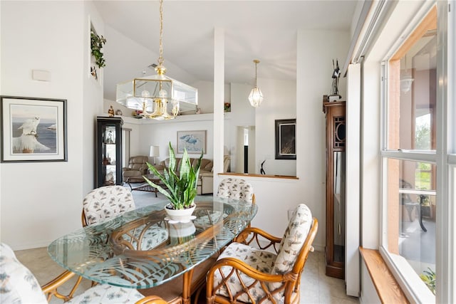 dining space featuring lofted ceiling and a notable chandelier