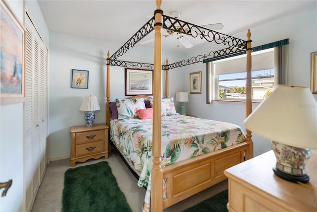 carpeted bedroom with ceiling fan and a closet