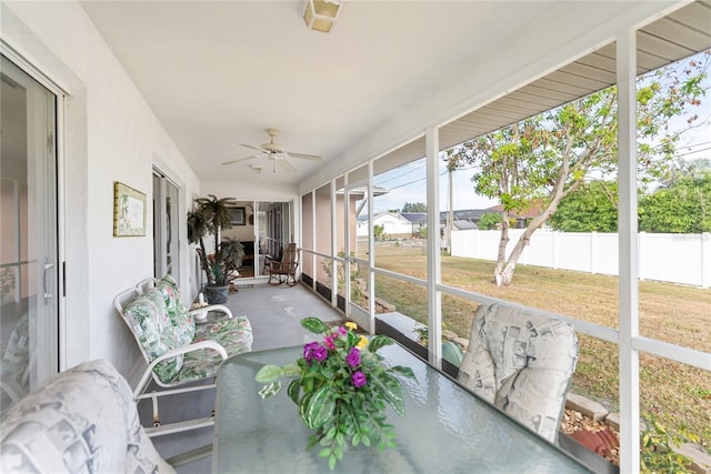 sunroom with ceiling fan and plenty of natural light