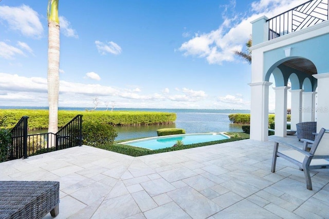 view of patio / terrace featuring a water view and a balcony