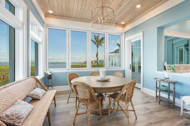 sunroom with wooden ceiling and a notable chandelier