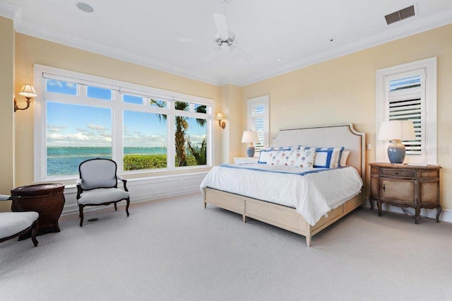 carpeted bedroom with ornamental molding, a water view, and ceiling fan