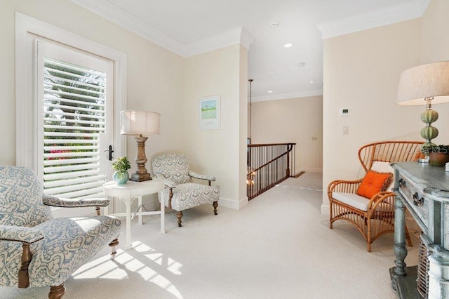 sitting room with light carpet and ornamental molding