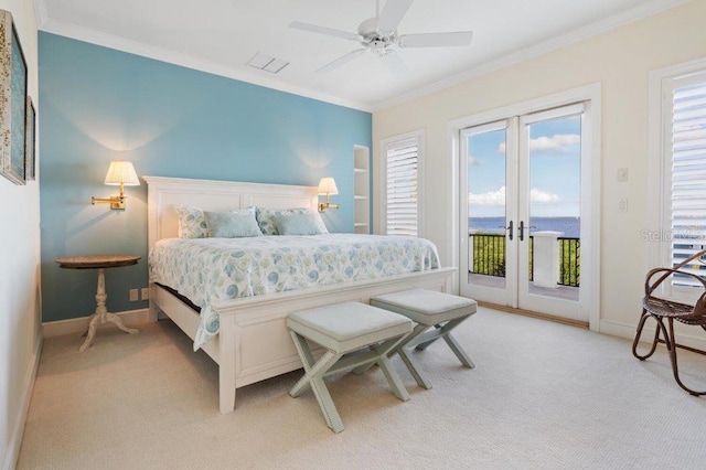 carpeted bedroom featuring multiple windows, french doors, and crown molding