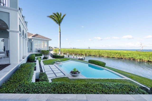 view of swimming pool featuring a water view