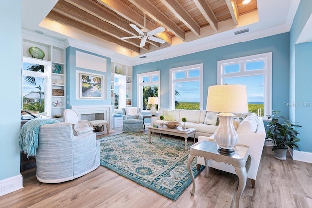 sunroom / solarium featuring beam ceiling, built in shelves, crown molding, wooden ceiling, and light wood-type flooring