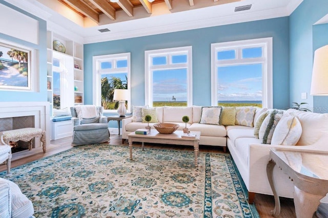 living room featuring wood-type flooring, built in shelves, and ornamental molding