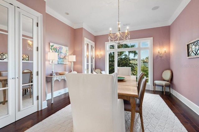 dining area with french doors, ornamental molding, dark hardwood / wood-style floors, and an inviting chandelier