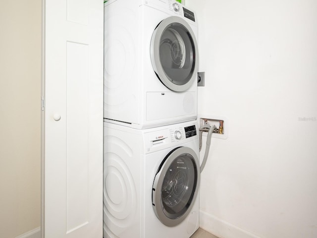 washroom featuring stacked washing maching and dryer