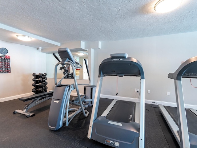 exercise room with a textured ceiling