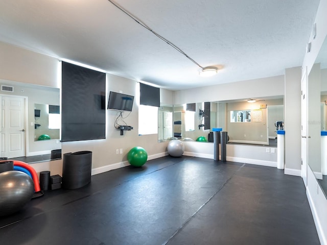 workout room with a textured ceiling