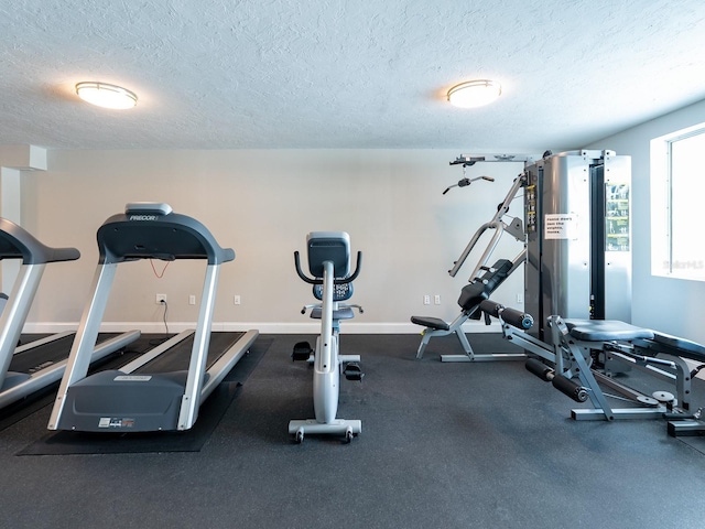 workout room featuring a textured ceiling