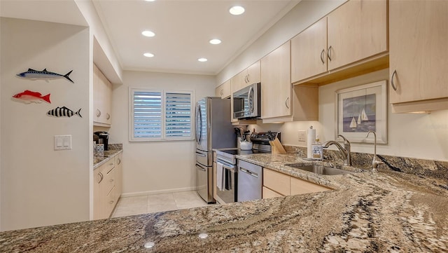 kitchen featuring light brown cabinetry, sink, crown molding, stainless steel appliances, and light stone countertops