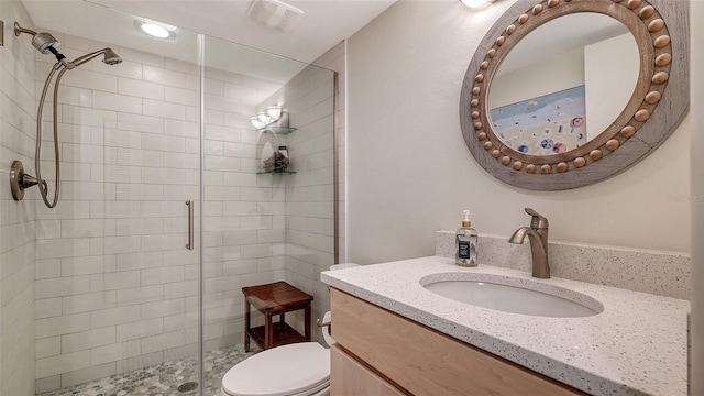 bathroom with vanity, toilet, and walk in shower