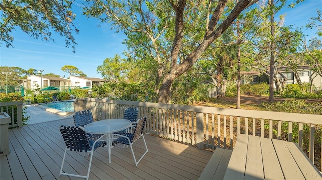 wooden terrace with a fenced in pool