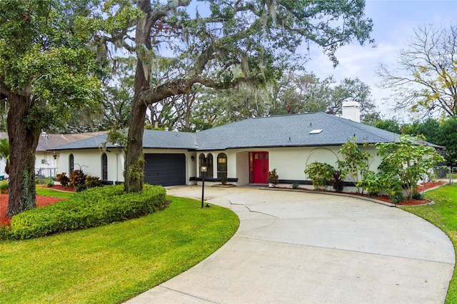 single story home with a garage and a front yard