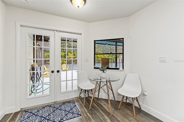 doorway featuring french doors, dark hardwood / wood-style flooring, and a textured ceiling