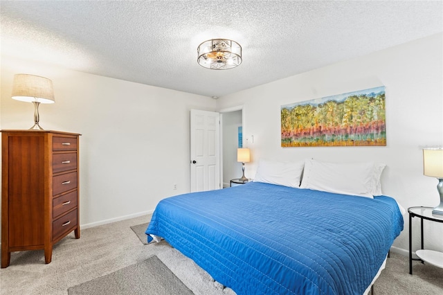 carpeted bedroom featuring a textured ceiling