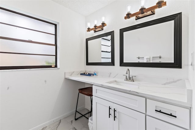 bathroom with vanity and a textured ceiling