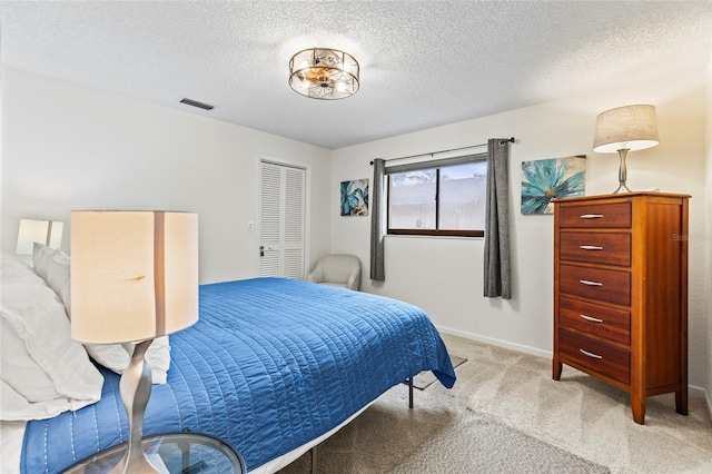 carpeted bedroom featuring a textured ceiling