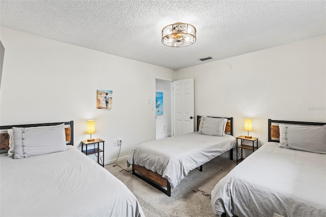 carpeted bedroom featuring a textured ceiling