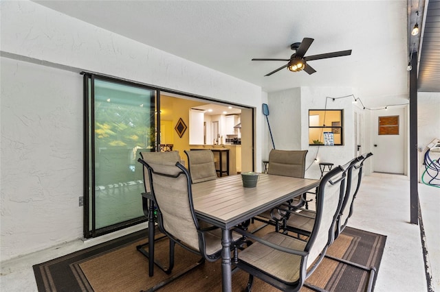 dining space featuring concrete floors and ceiling fan