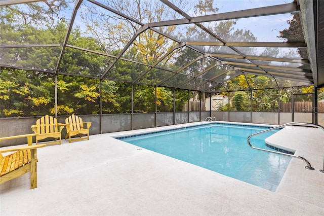 view of swimming pool featuring glass enclosure and a patio area