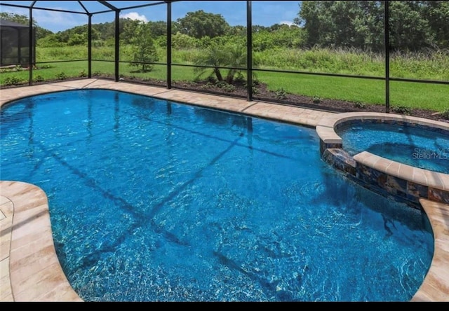 view of pool featuring glass enclosure and an in ground hot tub