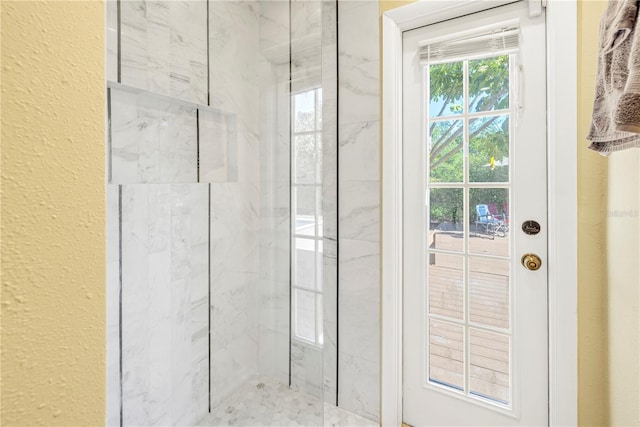 bathroom featuring a tile shower