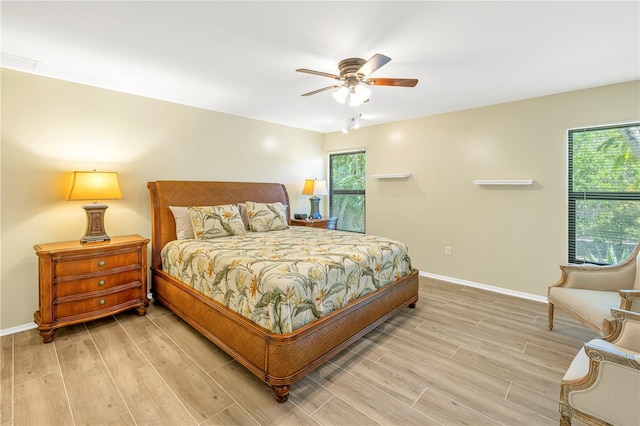 bedroom with ceiling fan and light hardwood / wood-style floors