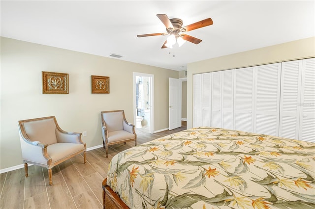 bedroom with ensuite bathroom, a closet, ceiling fan, and light wood-type flooring