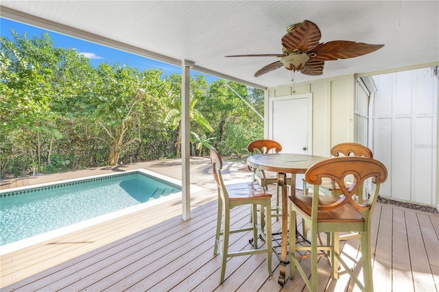 view of swimming pool featuring a deck and ceiling fan