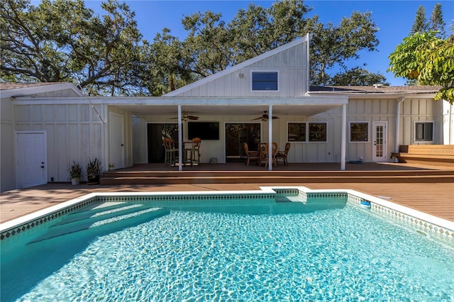 view of swimming pool featuring a wooden deck and ceiling fan