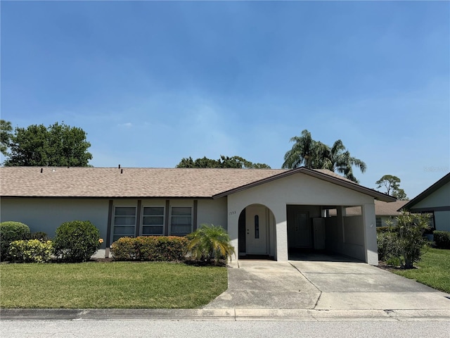 ranch-style house featuring a carport and a front lawn